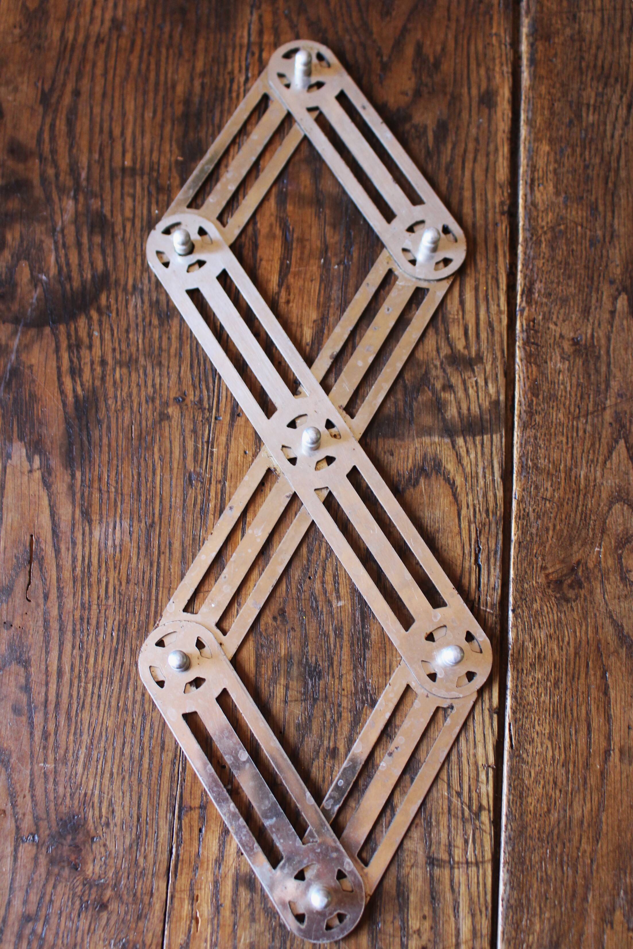 Vintage accordion folding metal trivet