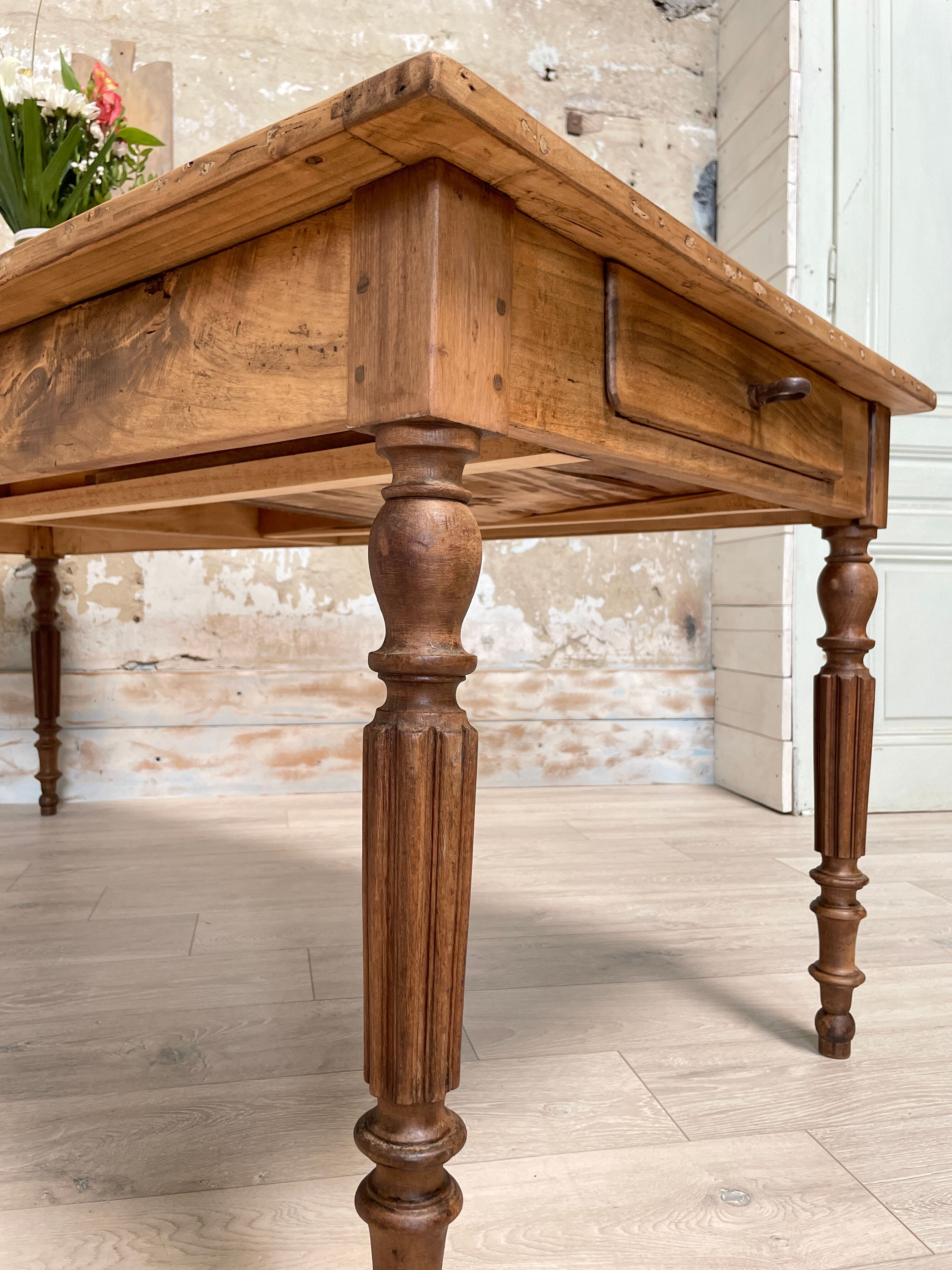 Vintage farmhouse table with turned legs.