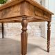 Vintage farmhouse table with turned legs.
