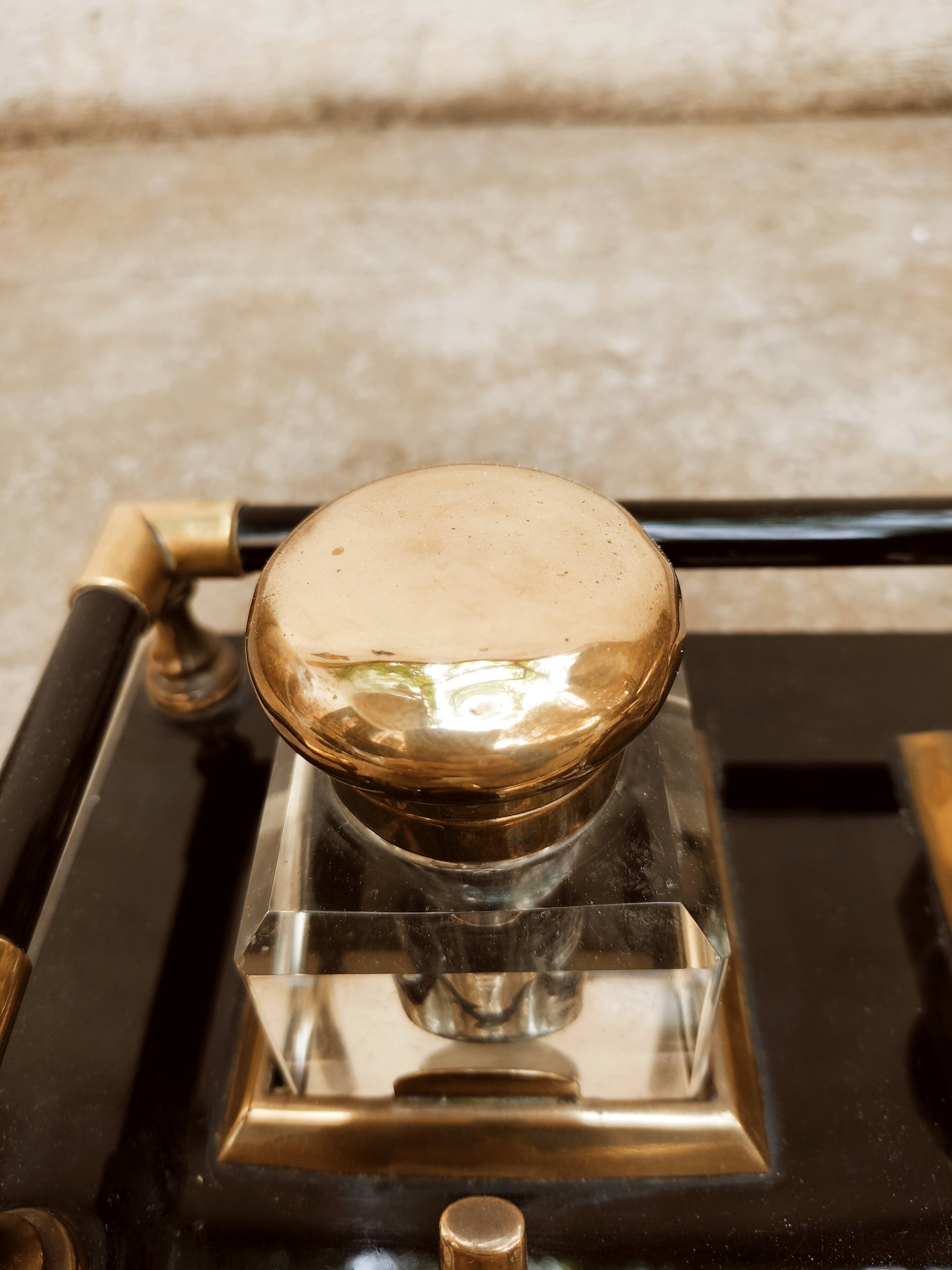 Hence the art deco inkwell on jet plate brass finishes