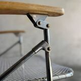 Pair of vintage silver aluminum wire folding chairs with wooden armrests — industrial minimalist