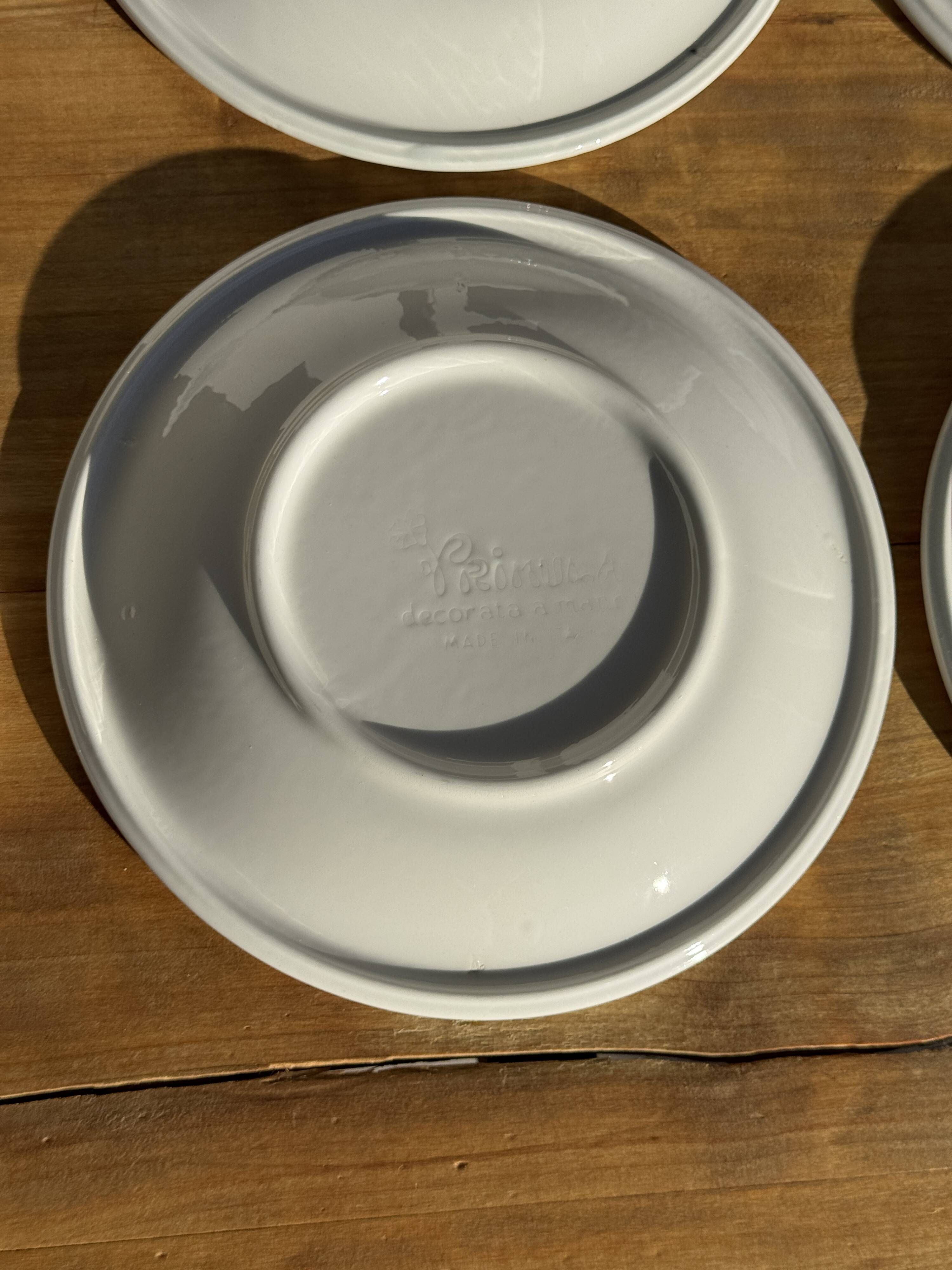 Set of 9 small Italian dessert plates Primula with red and green trim.