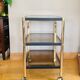Side table in gold metal and smoked glasses 1970s