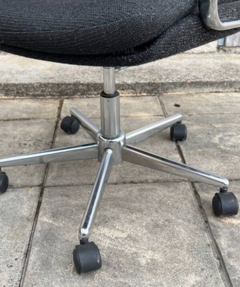 Black mottled fabric and chrome swivel armchair, 1