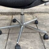 Black mottled fabric and chrome swivel armchair, 1