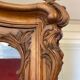 Large wooden display cabinet in Louis XV/rococo style with a strongly curved front.