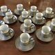 Un lot de 13 tasses à moka soucoupe et porte tasse en étain intérieur tasse en porcelaine de limoges avec décor de filte gris