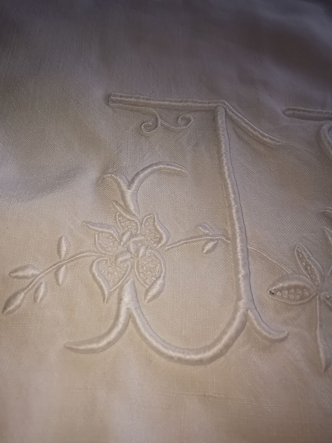 Antique embroidered linen sheet with a monogram.