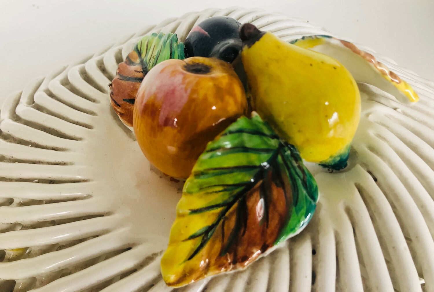 Covered basket in woven ceramic and fruit slip.