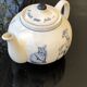 White porcelain teapot decorated with animals