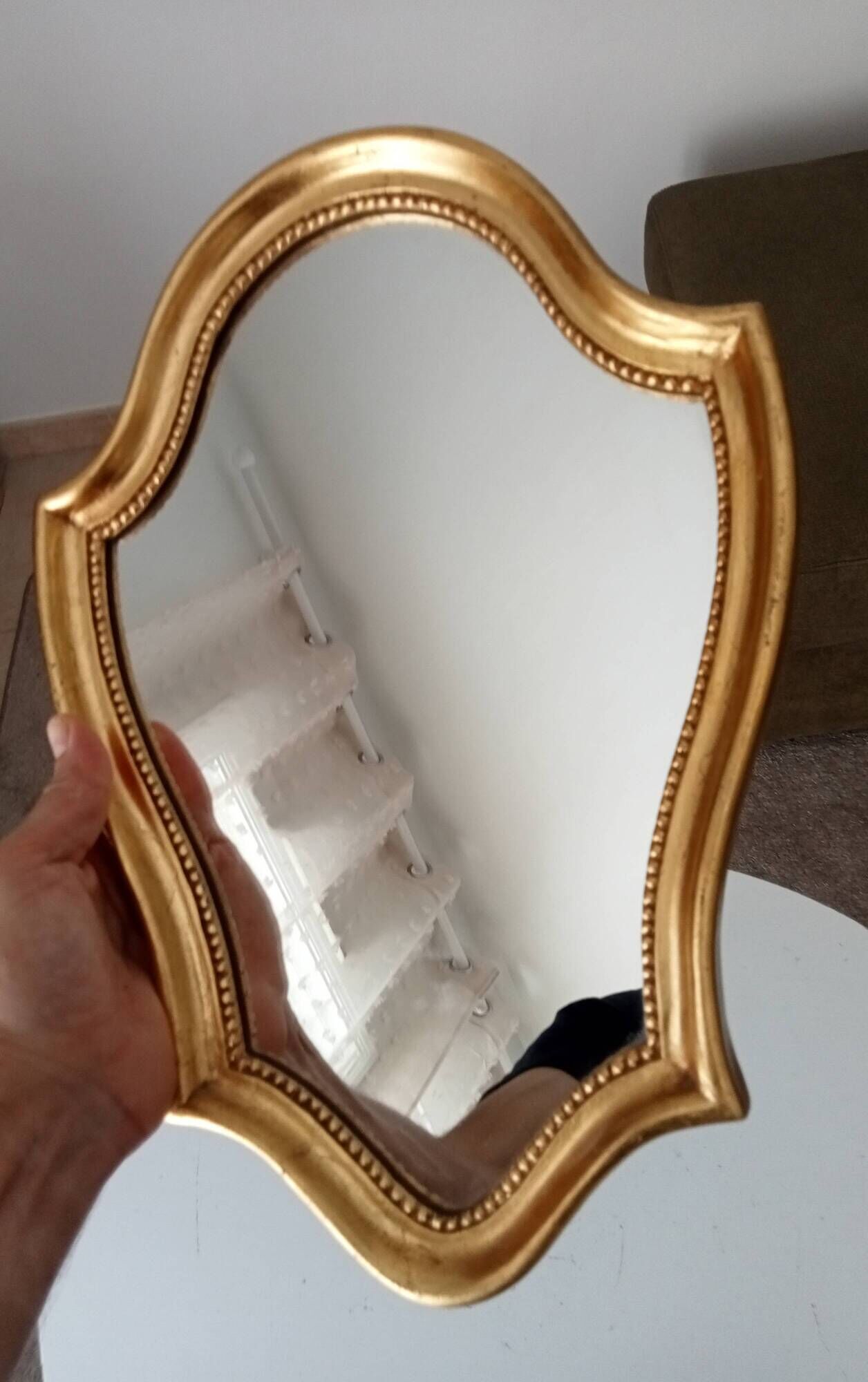 Vintage baroque mirror in gilded wood in the Louis XV style.