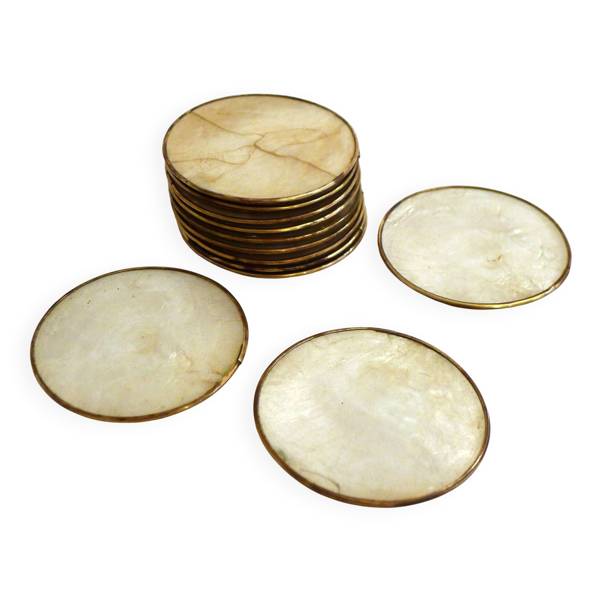 Set of 12 Mother of Pearl coasters with brass edging.