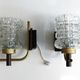 Pair of wall sconces in textured glass, wood, and gold metal, 1970.