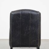 Black cow leather armchair in industrial style finished with decorative nails