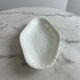 Oval white porcelain ramekin — raised floral pattern