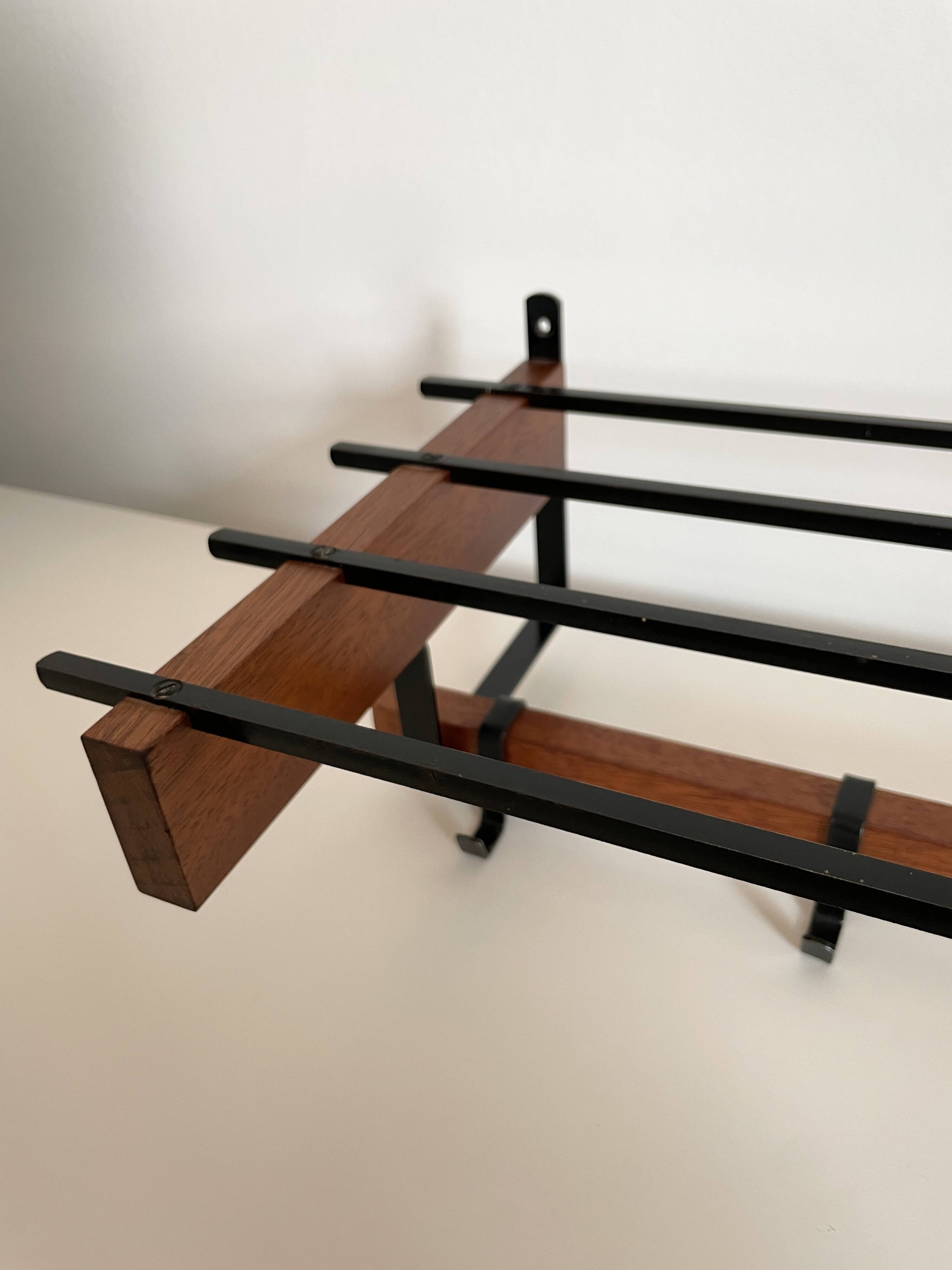 Vintage Scandinavian wall coat rack in wood and metal.