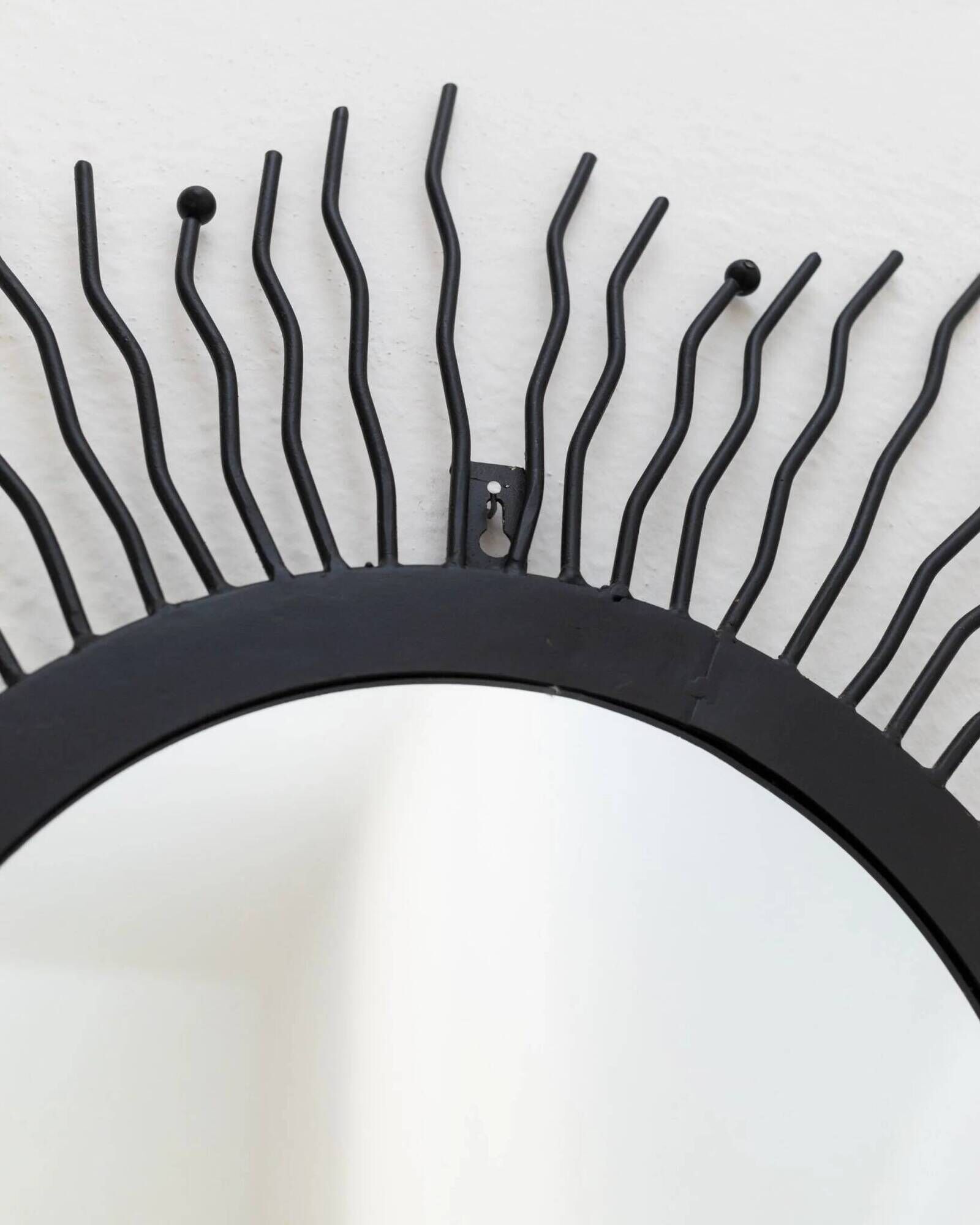 Black metal sunburst wall mirror, round 63x63 cm, vintage 1990s, made in Italy
