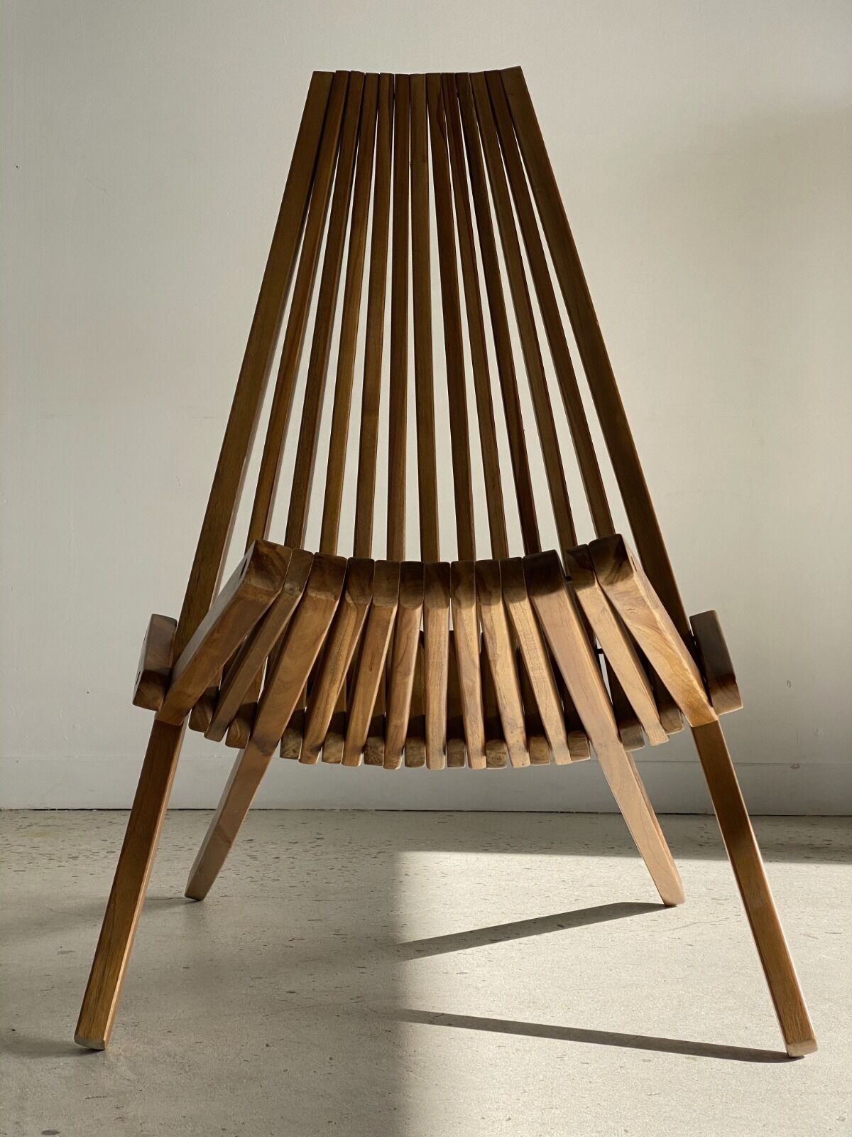 Foldable designer armchair in wooden slats