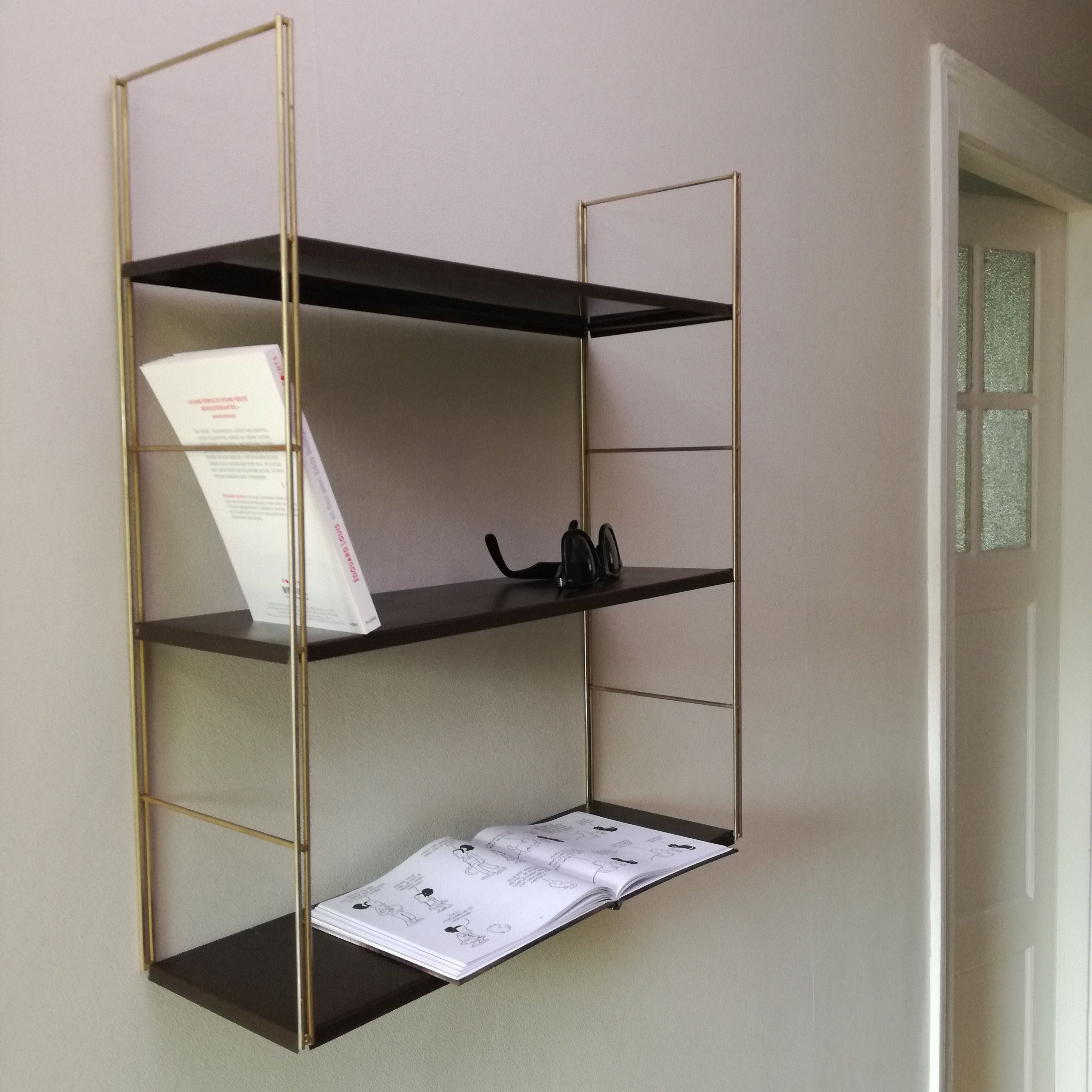 Golden and brown stringed shelf in metal
