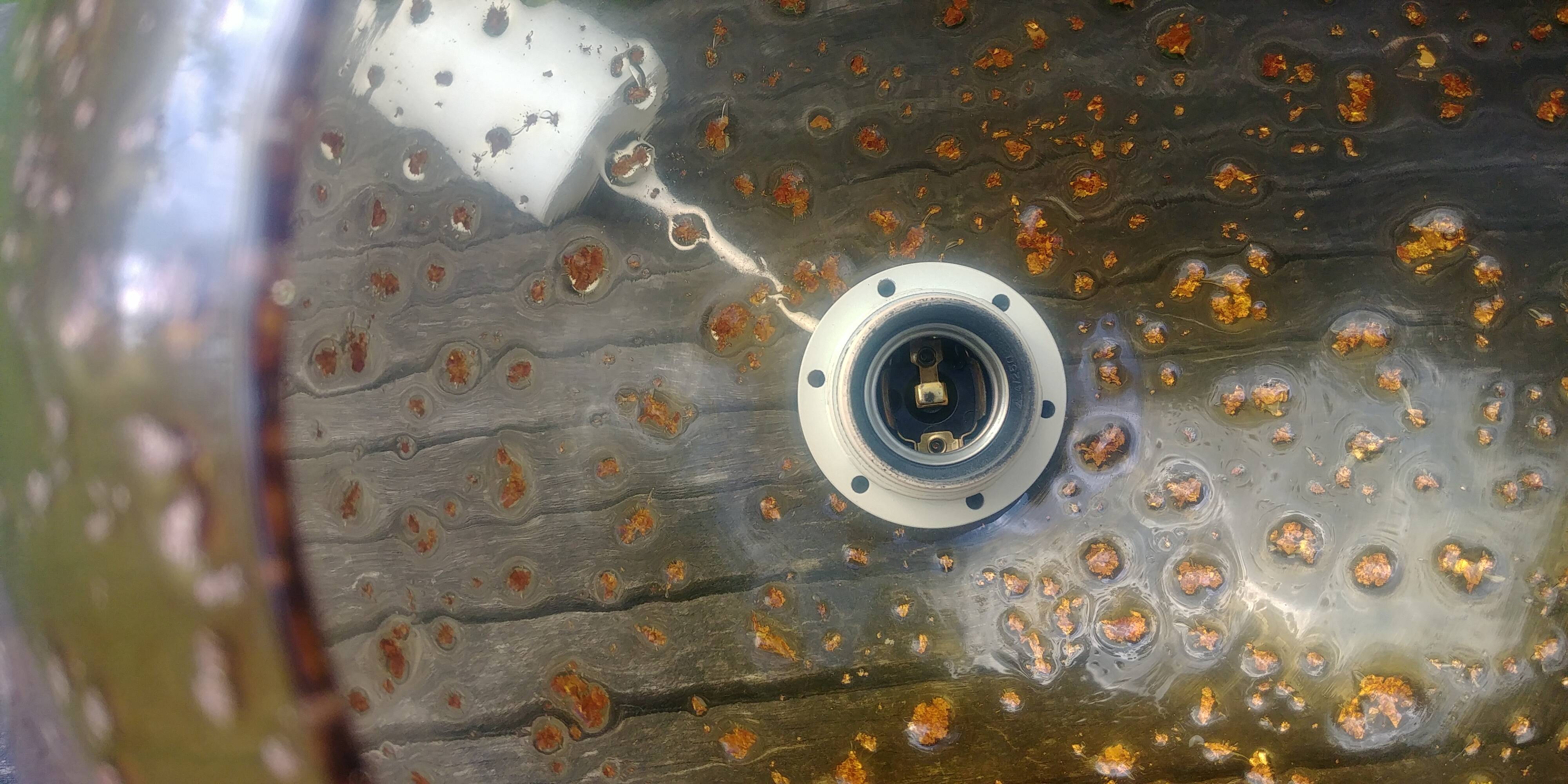 A vintage 70s blown glass pendant light with gold glitter in a globe shape