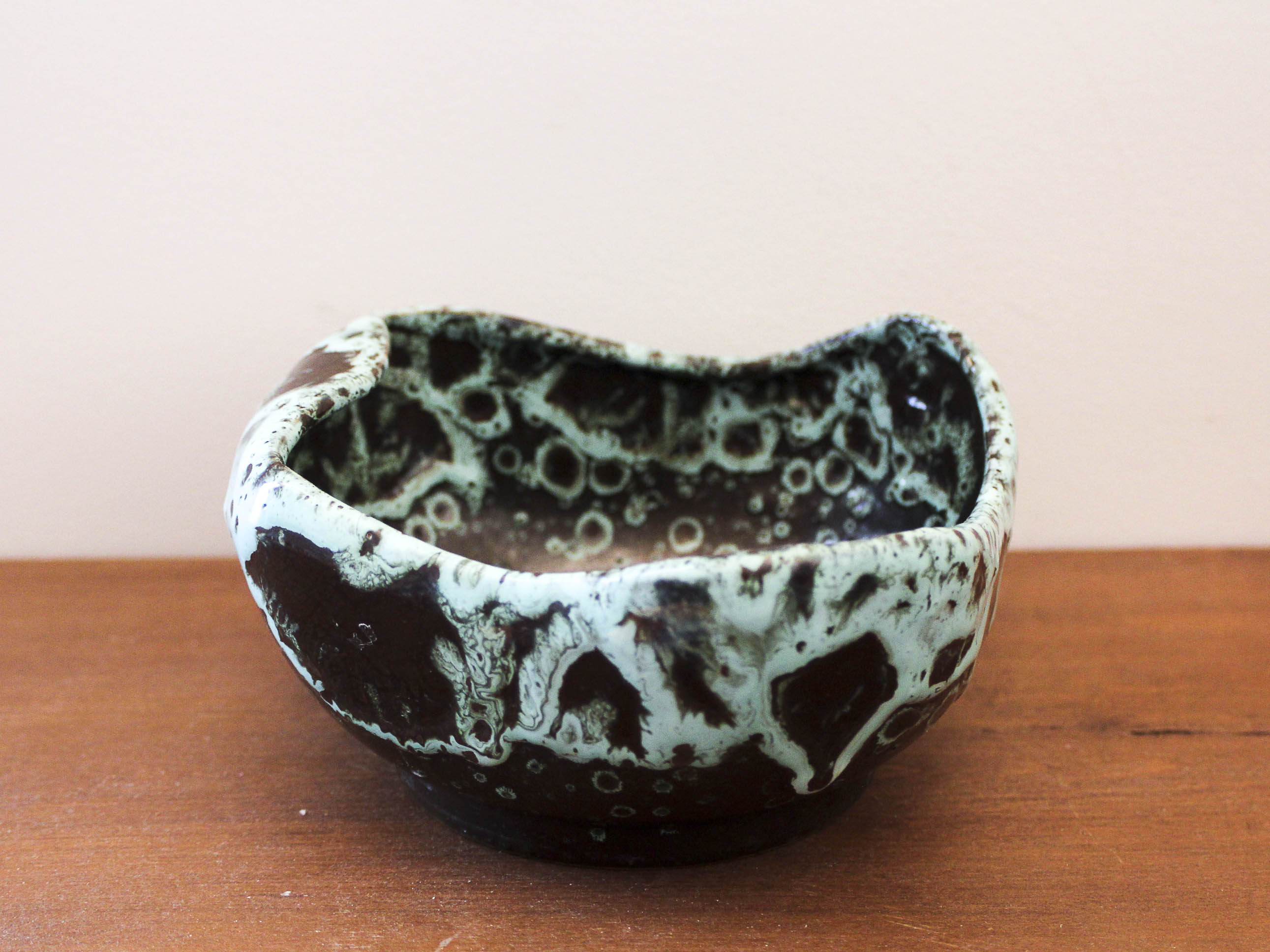 Empty pocket in black ceramic with green drip