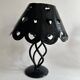 Pair of black wrought iron lanterns with heart patterns, romantic style.