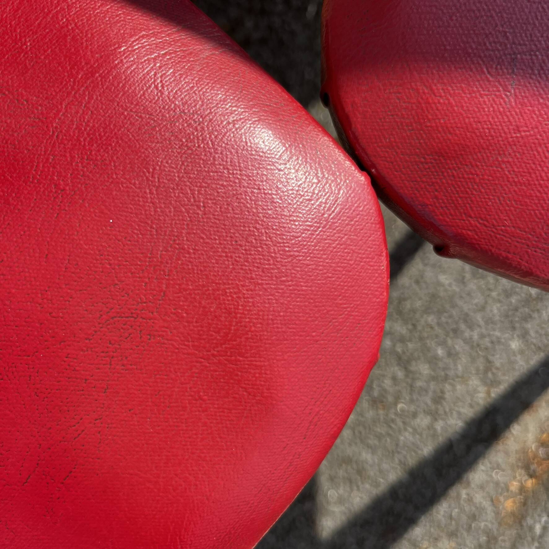 Set of 4 vintage bistro chairs in wood and red faux leather, with splayed legs.