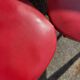 Set of 4 vintage bistro chairs in wood and red faux leather, with splayed legs.