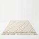 Berber wool rug with abstract white patterns