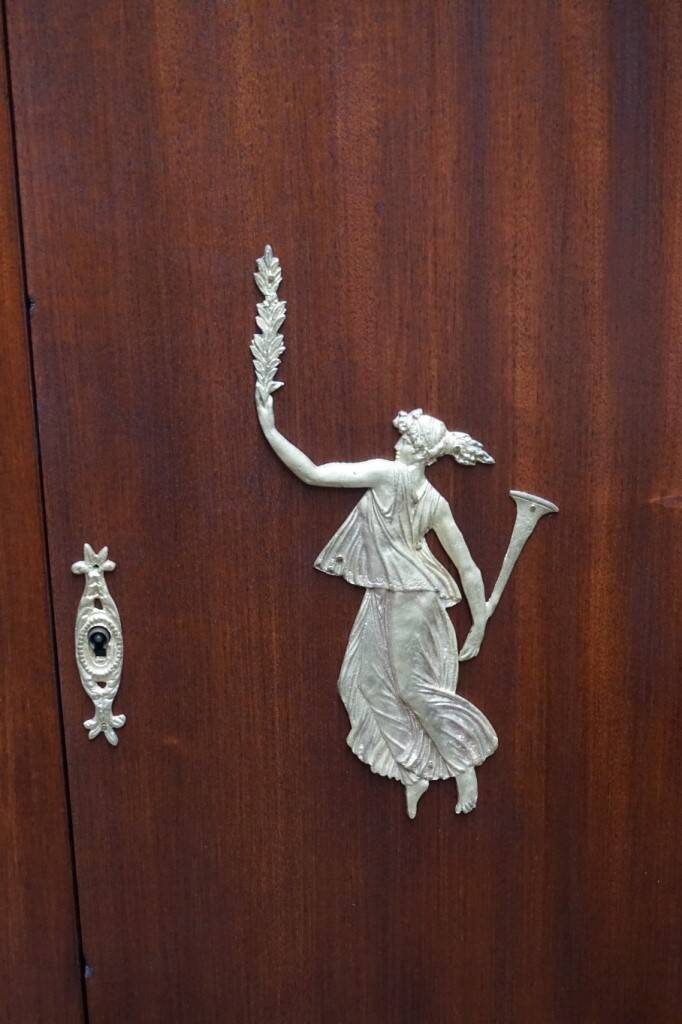 Empire style mahogany display bookcase with gilt bronze decoration and three doors.