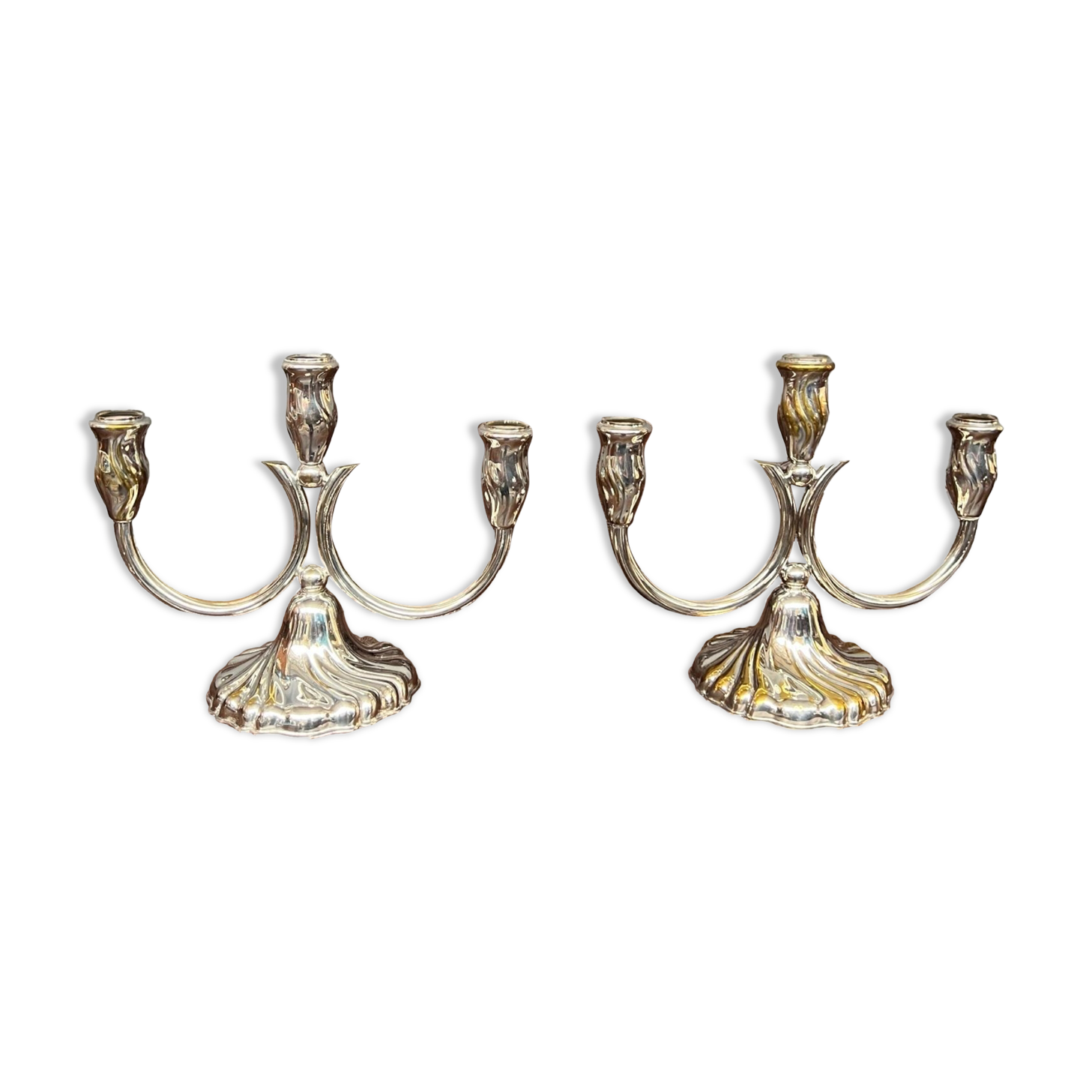 A pair of candlesticks. silver metal with gold decoration.