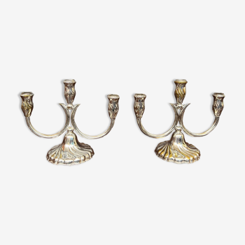 A pair of candlesticks. silver metal with gold decoration.