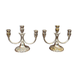 A pair of candlesticks. silver metal with gold decoration.