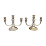 A pair of candlesticks. silver metal with gold decoration.