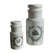 A pair of white glass bottles with Italian green patterns.
