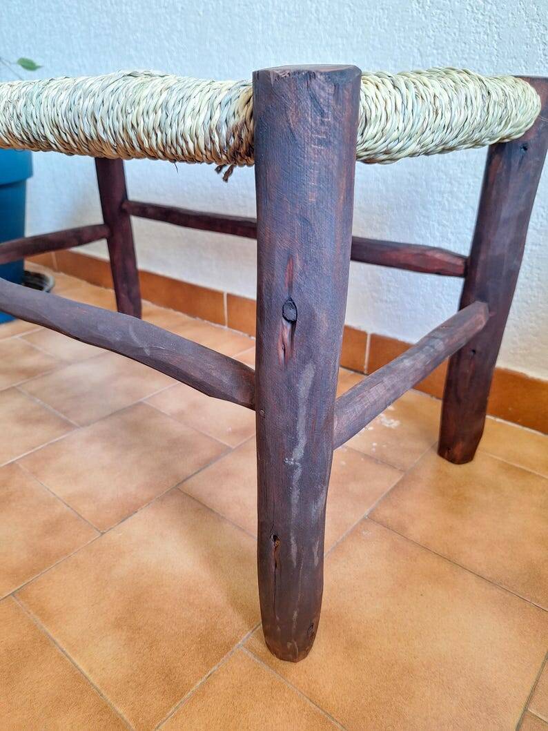Moroccan bench in dark wood with woven palm leaf seat