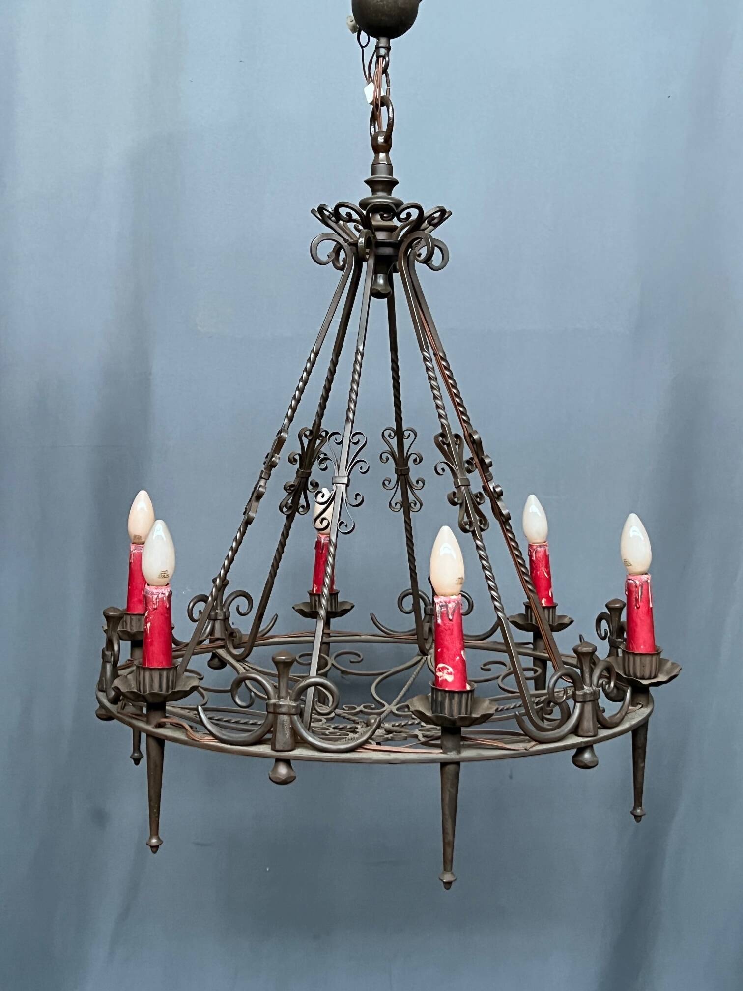 Wrought chandelier in Gothic style.