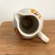 Vintage Maine St Amand earthenware pitcher with floral decorations