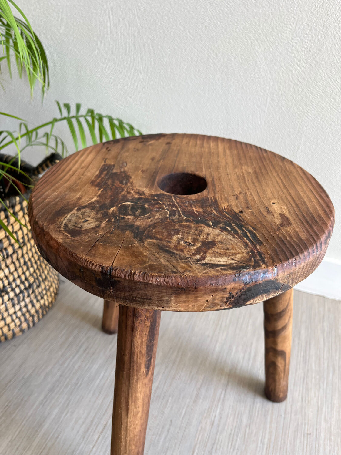 Three-legged wooden stool