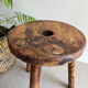 Three-legged wooden stool