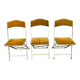 Three folding opera chairs in old gold velvet and brass structure