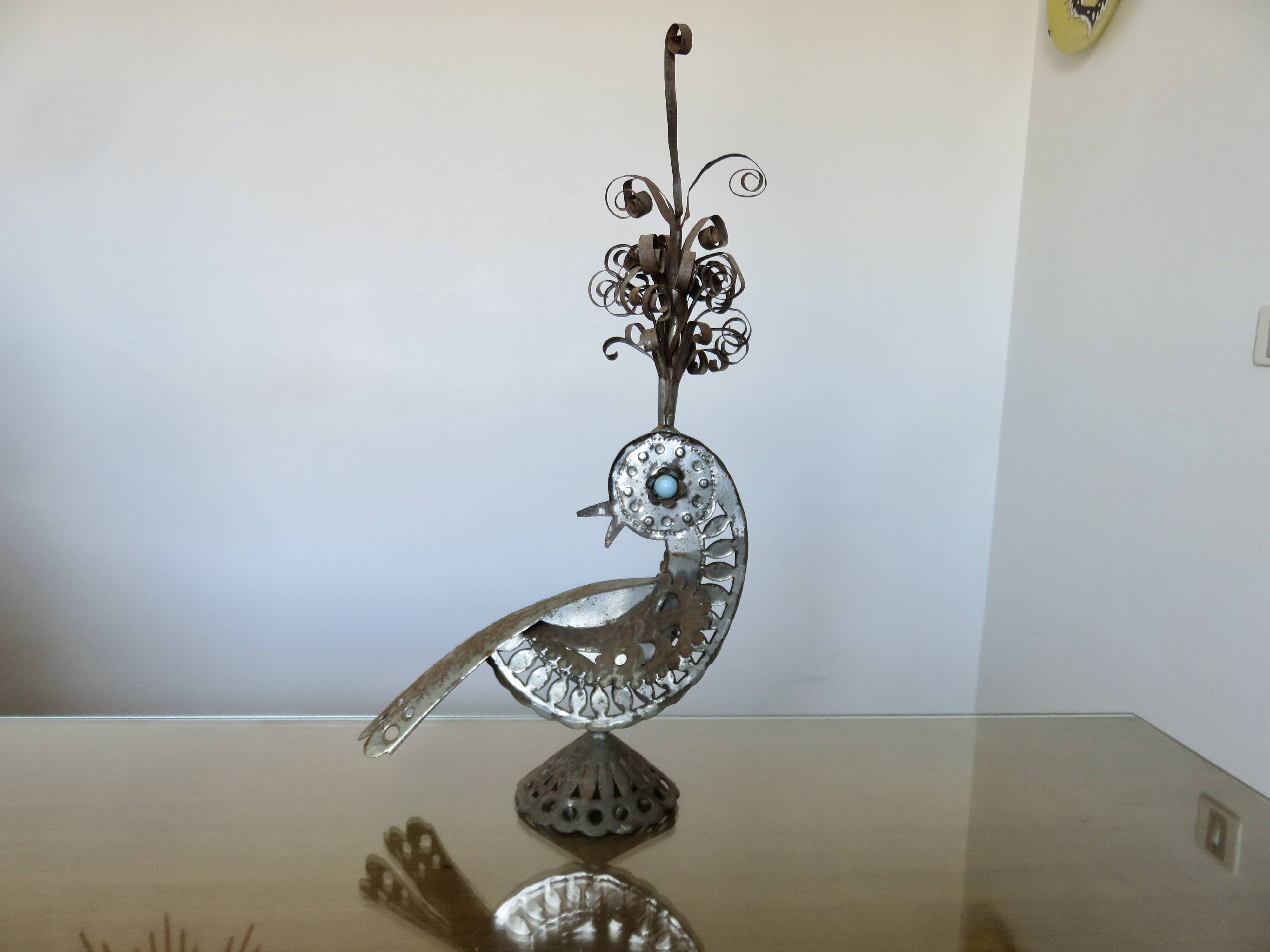 metal sculpture in sheet metal representing a peacock, work from the 1960s
