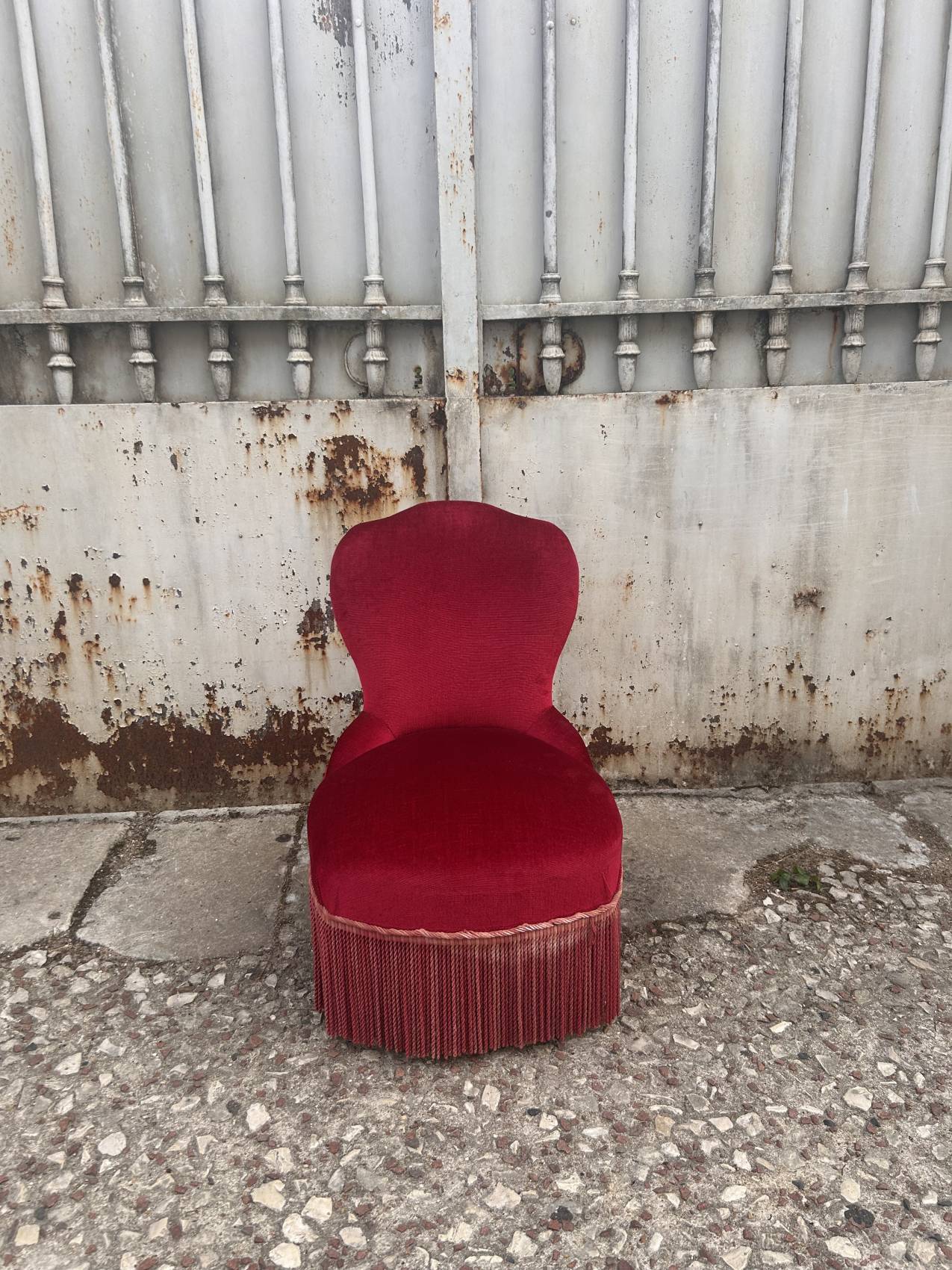 Vintage burgundy velvet armchair with fringes – theatrical and elegant