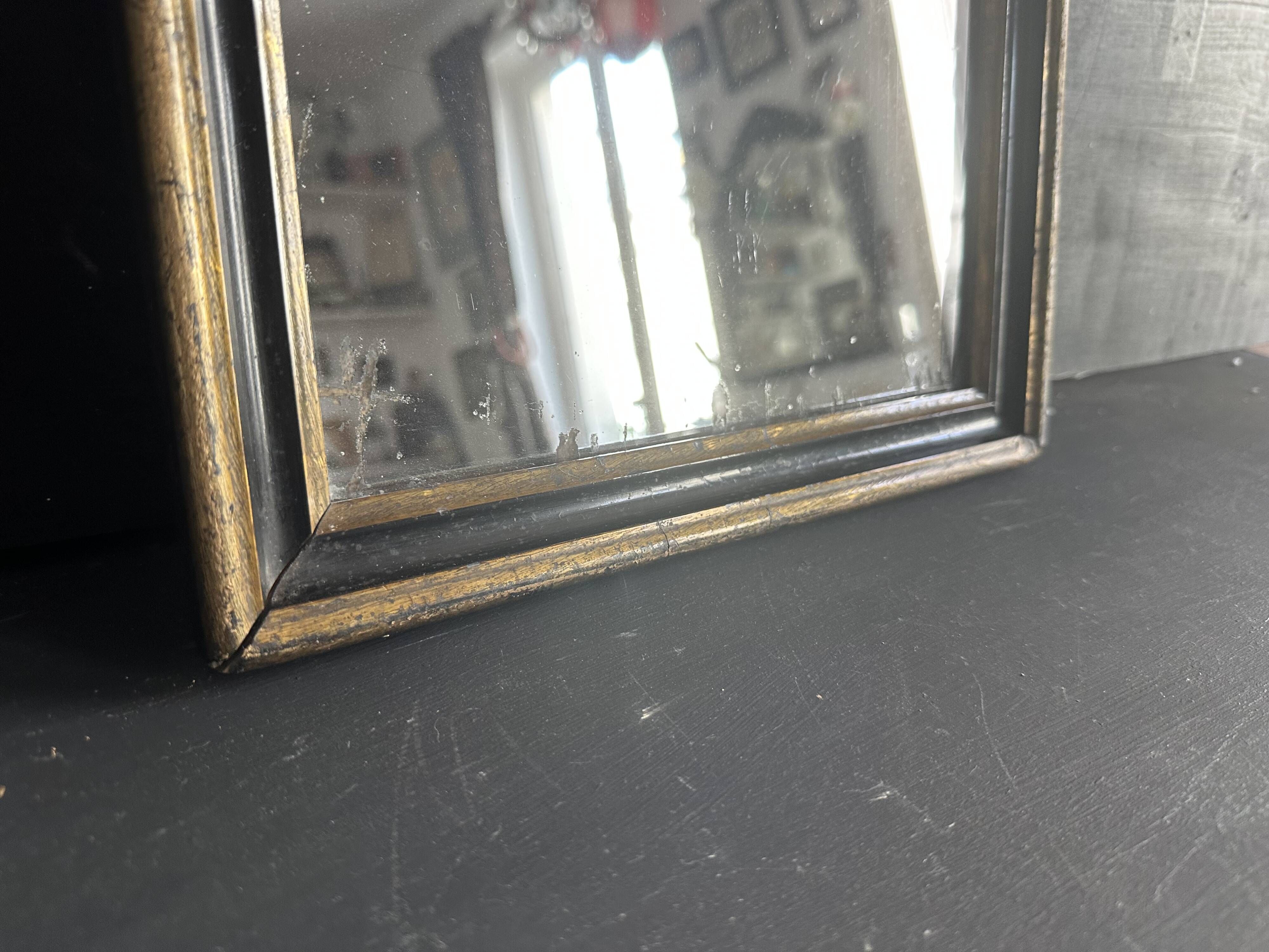 Miroir Napoléon III en bois noir et doré, XIXe siècle