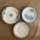 3 mismatched iron earth flat plates in green.