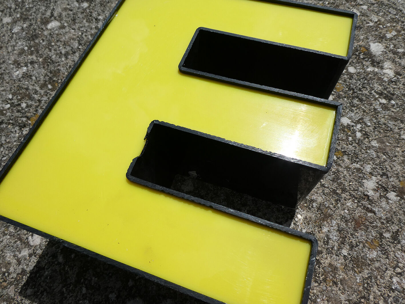 Yellow and black industrial sign letter "E"