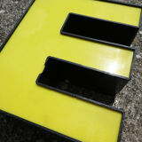 Yellow and black industrial sign letter "E"