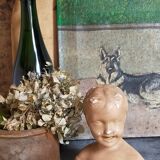 Bust of a small child in ancient plaster