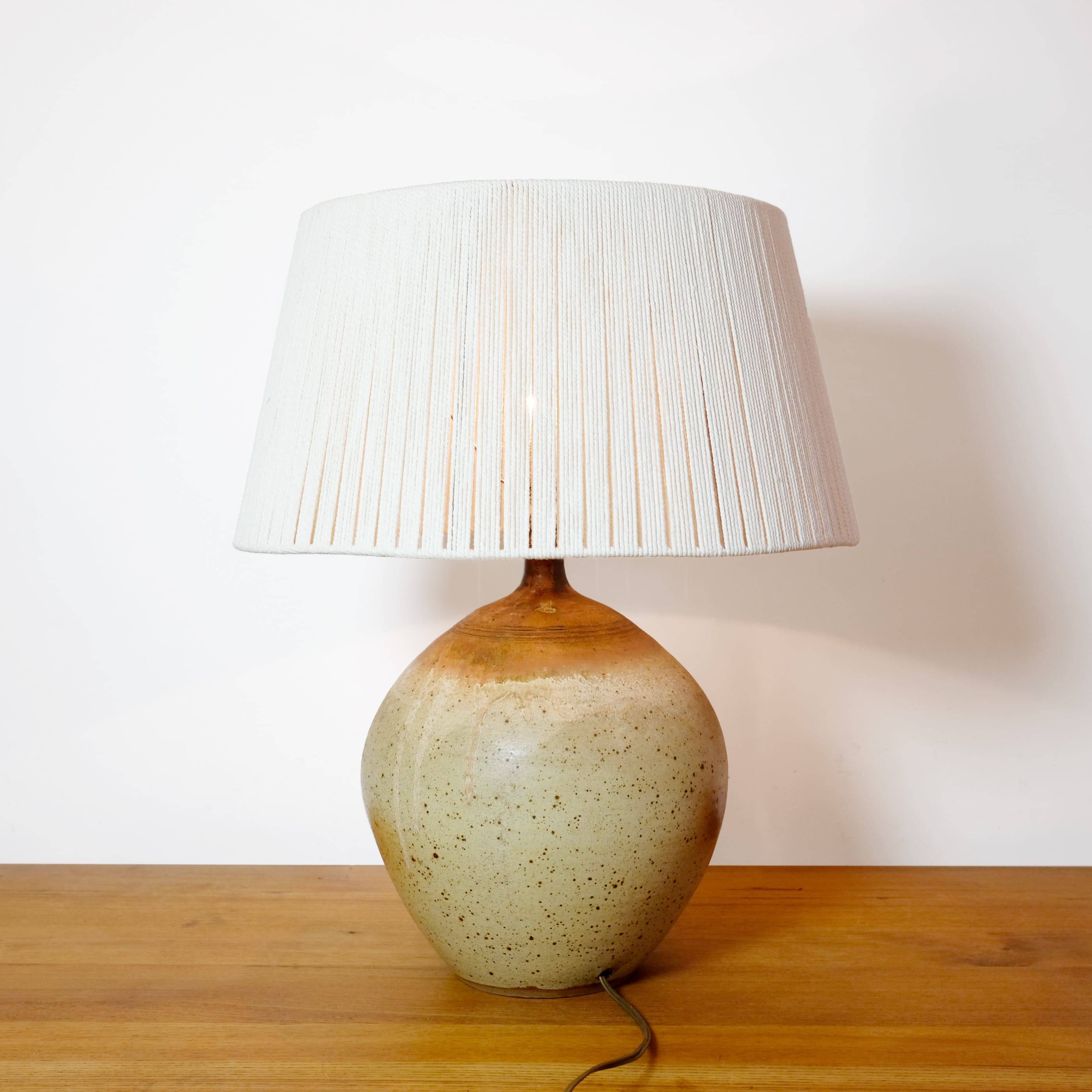 Large stone lamp with a cotton shade.