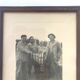 Fishing trophy with radiant faces, c. 1950. Black and white photograph.